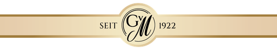 Ein elegantes, goldenes Banner mit dem Schriftzug 'SEIT 1922' und einem stilisierten 'M' in der Mitte.